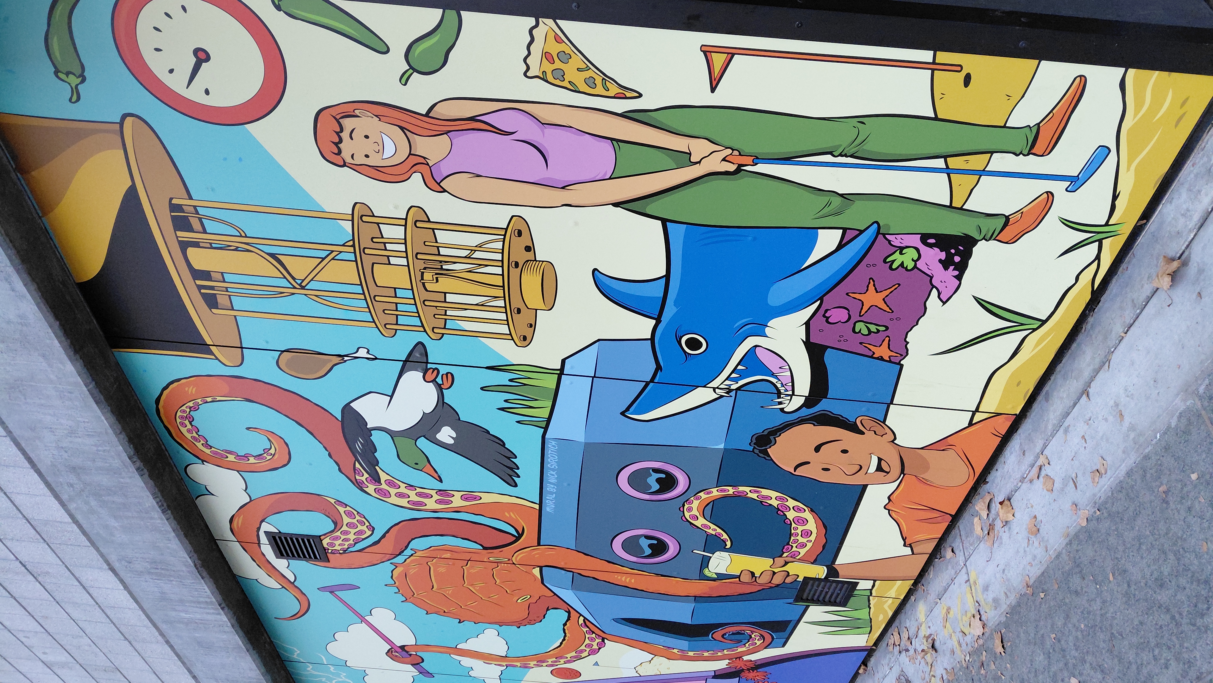 Colorful cartoon-style mural with octopus, shark, and mini-golf character on a San Jose wall